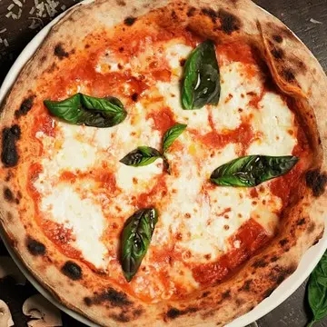 Burrata pizza with a whole burrata and basil.