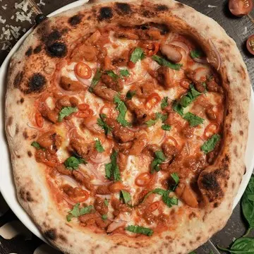 Il Malese pizza topped with chicken satay, chilli and cilantro.