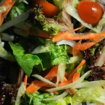Mixed garden salad with carrot, cucumber and cherry tomatoes.