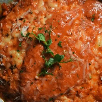 Lasagne al forno baked with beef ragù and béchamel.