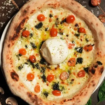 Pomodorini e Pesto pizza with a whole burrata at the centre.