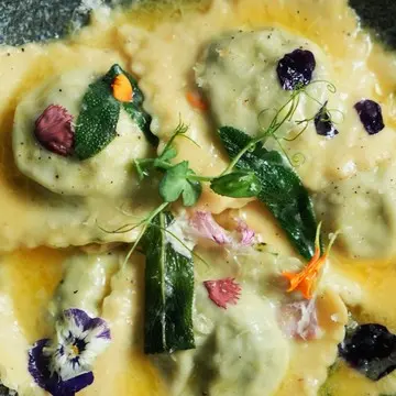 Ravioli filled with ricotta and spinach in sage butter.